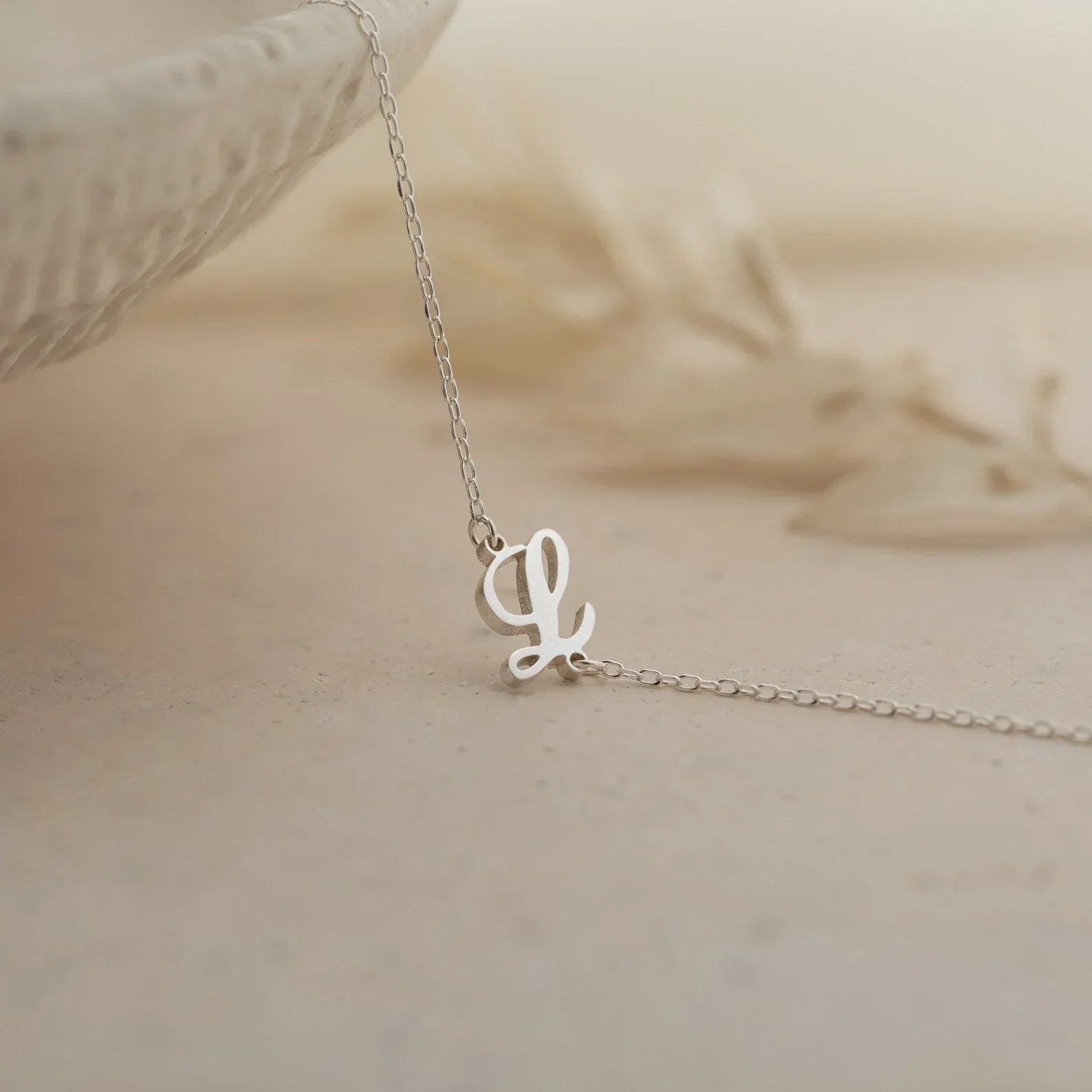 Product image of the Eraya Jewel 'Carrie Font' Initial Bracelet in polished Silver, detailing the distinctive 'Carrie' script style initial.