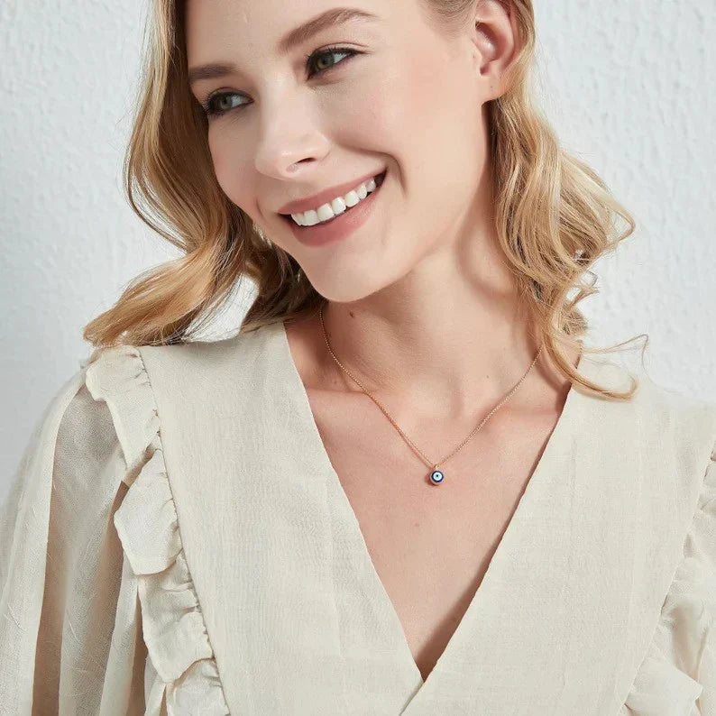Model wearing the Evil Eye Protector Pendant, a stylish blue accessory that offers spiritual protection and wards off negative energy