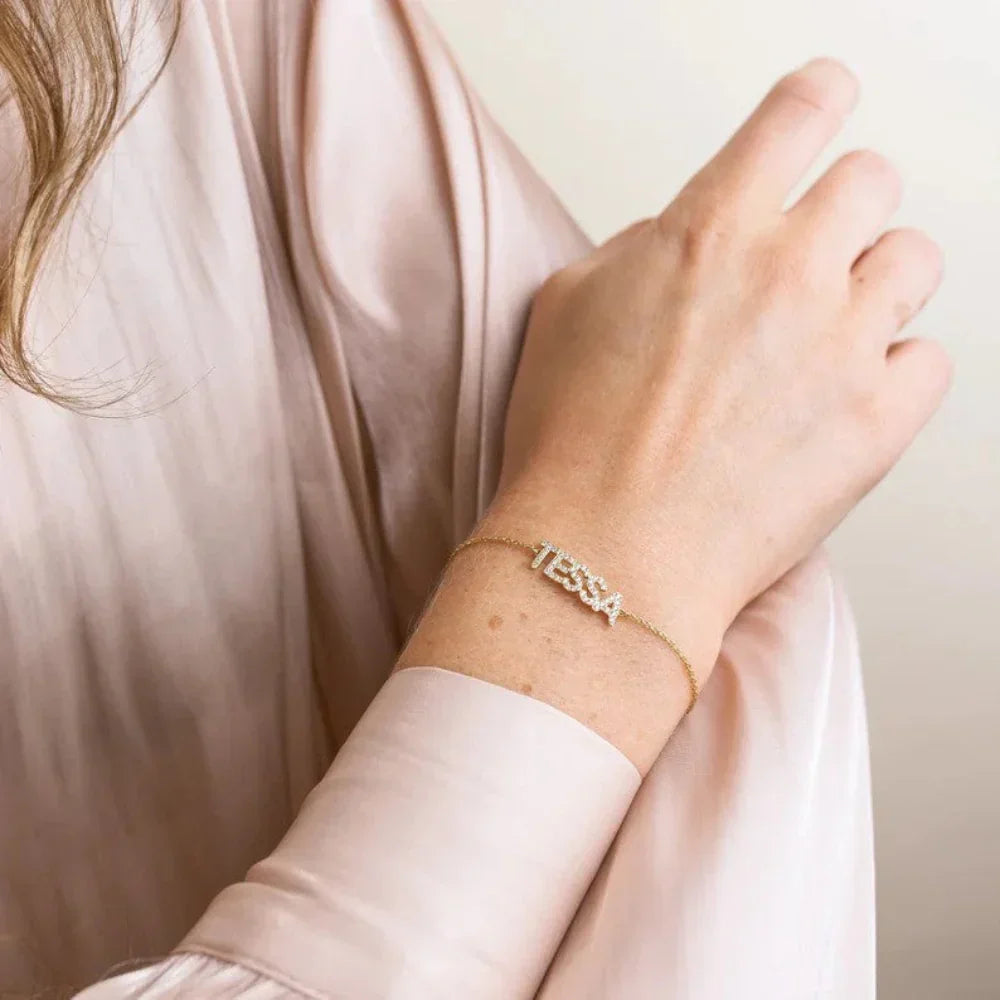 Model elegantly wearing an Eraya Jewel Custom Diamond Name Bracelet, with a personalized name sparkling with brilliant diamonds on her wrist.