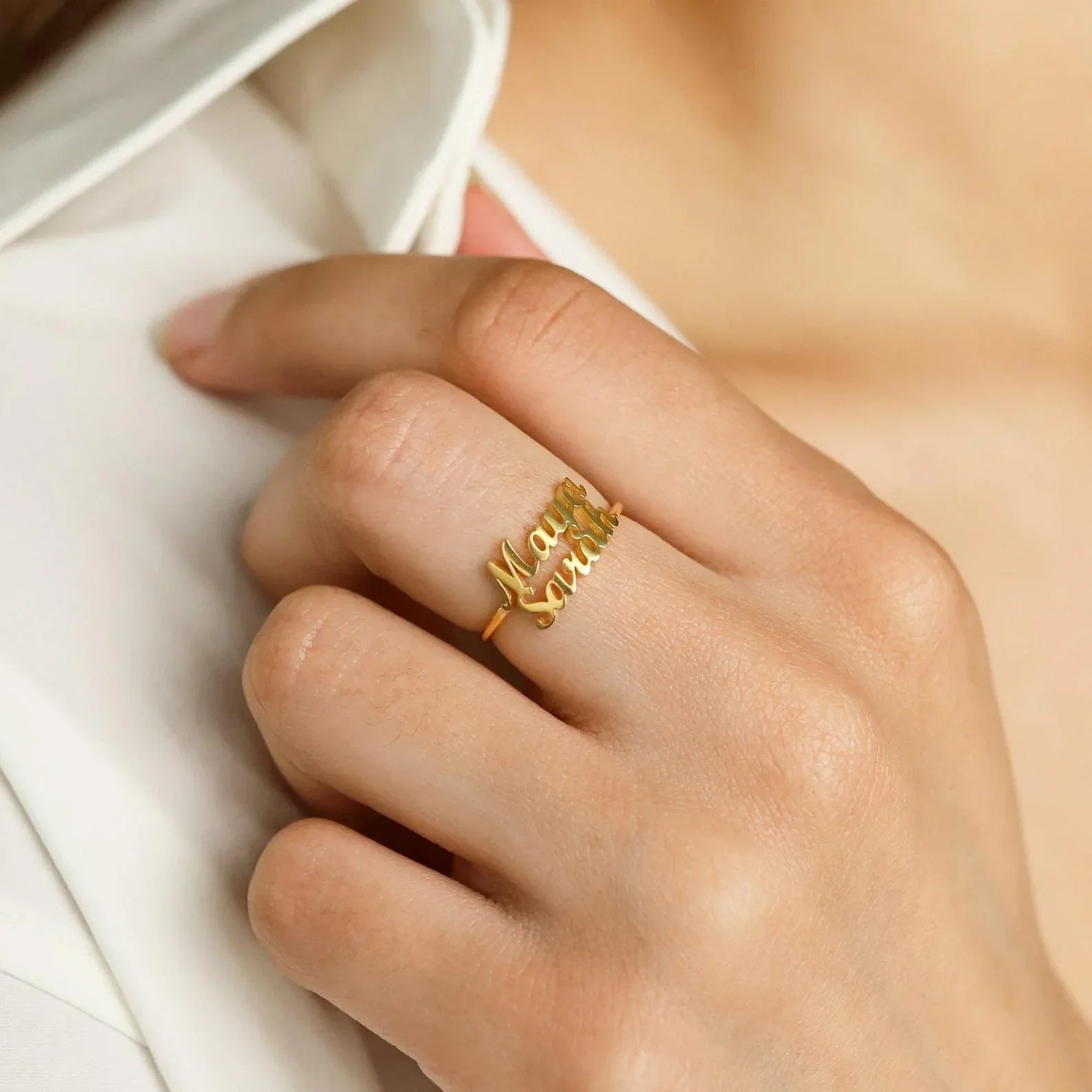 A detailed close-up showcasing the engraved names on two matching London-style rings, highlighting the craftsmanship and elegant design.