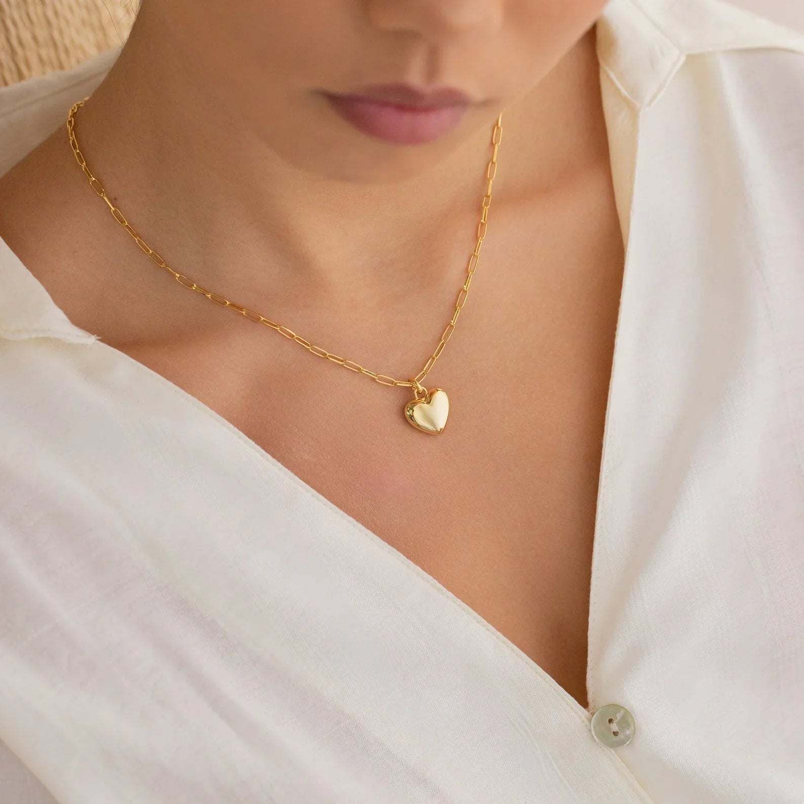 Model wearing the Paperclip Heart Pendant, highlighting its modern, minimalist design and romantic detail.