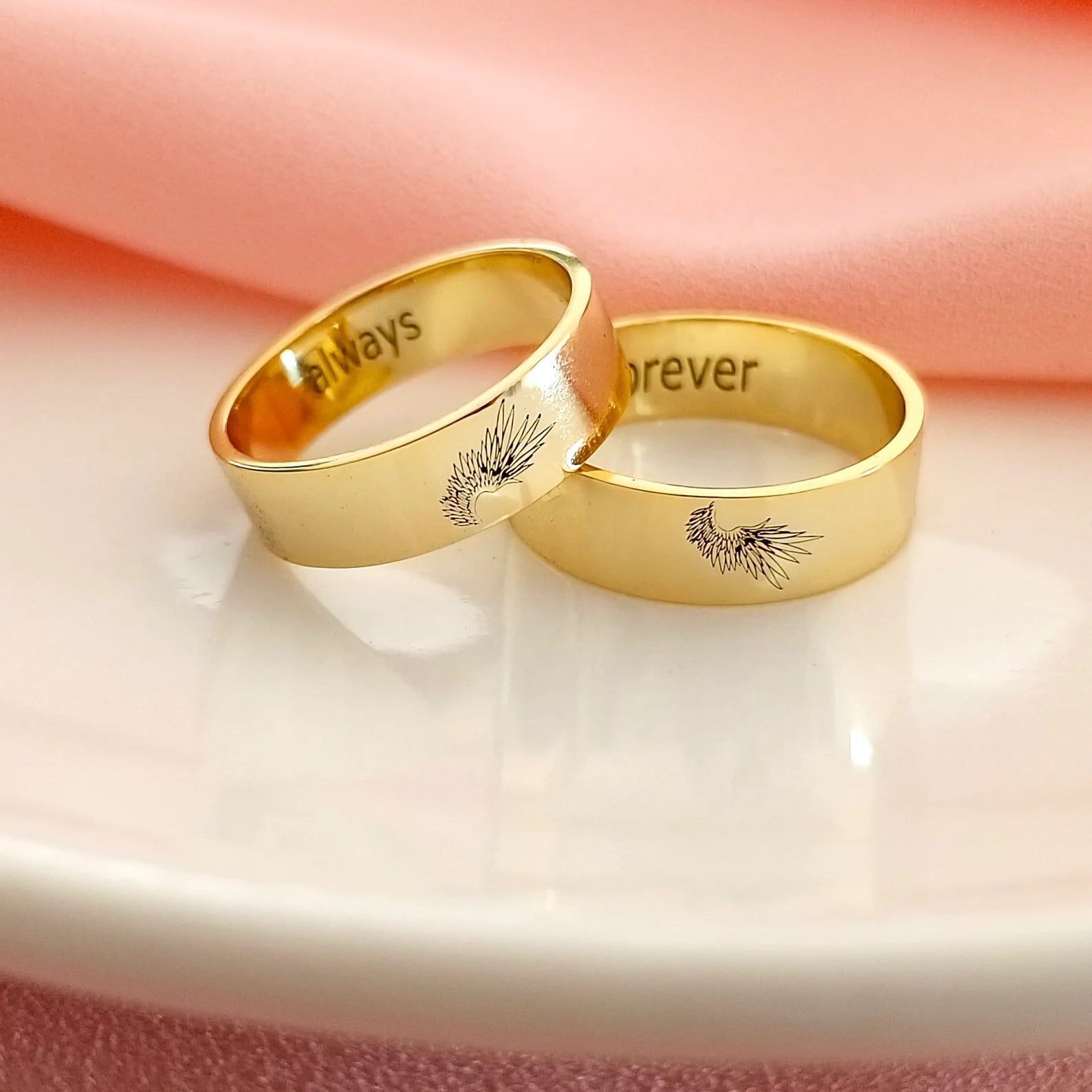 Close-up view highlighting the intricate feather details on a polished Angel Wing Couple Ring.