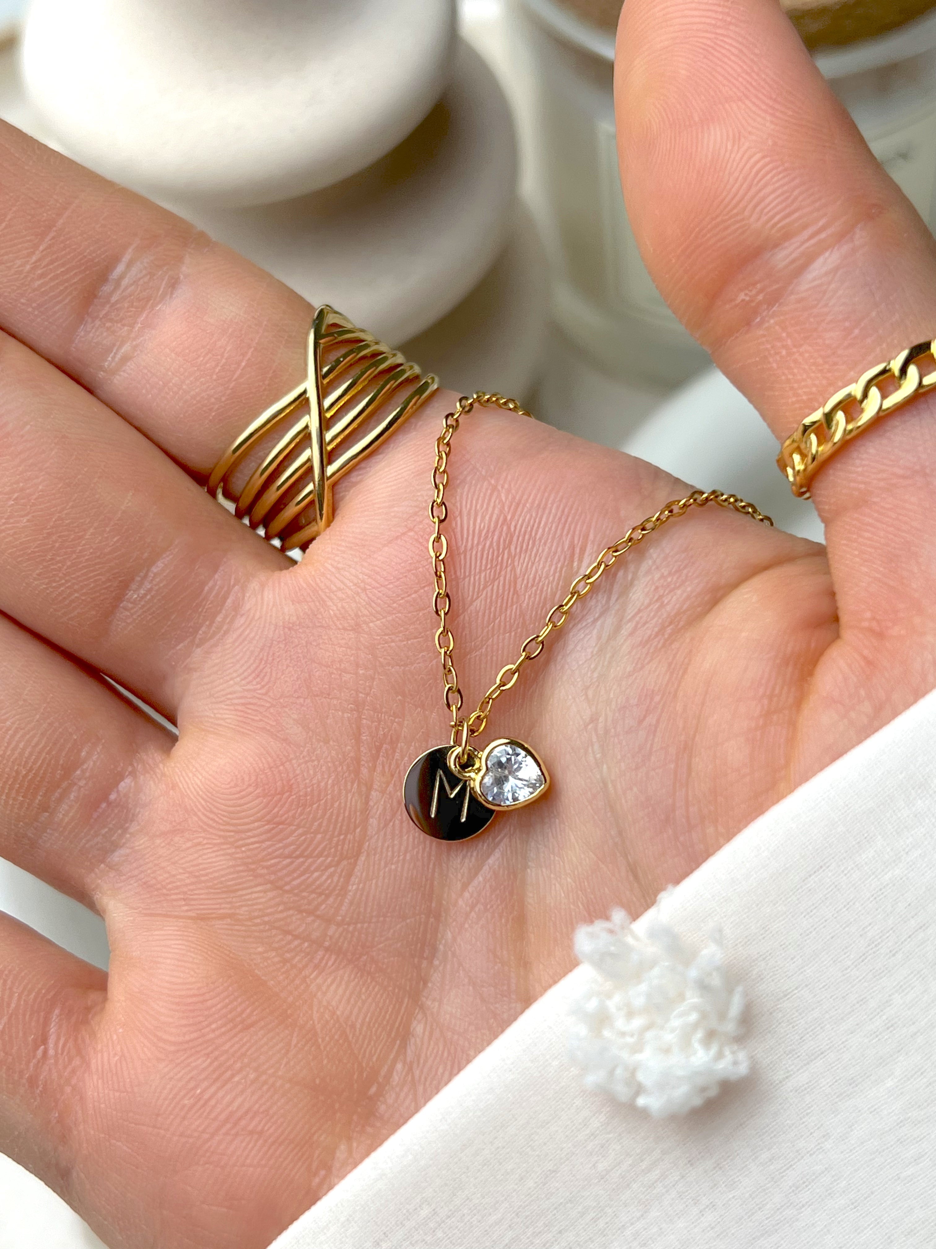 Silver polished initial pendant necklace with hidden engraving, styled for a minimal everyday look